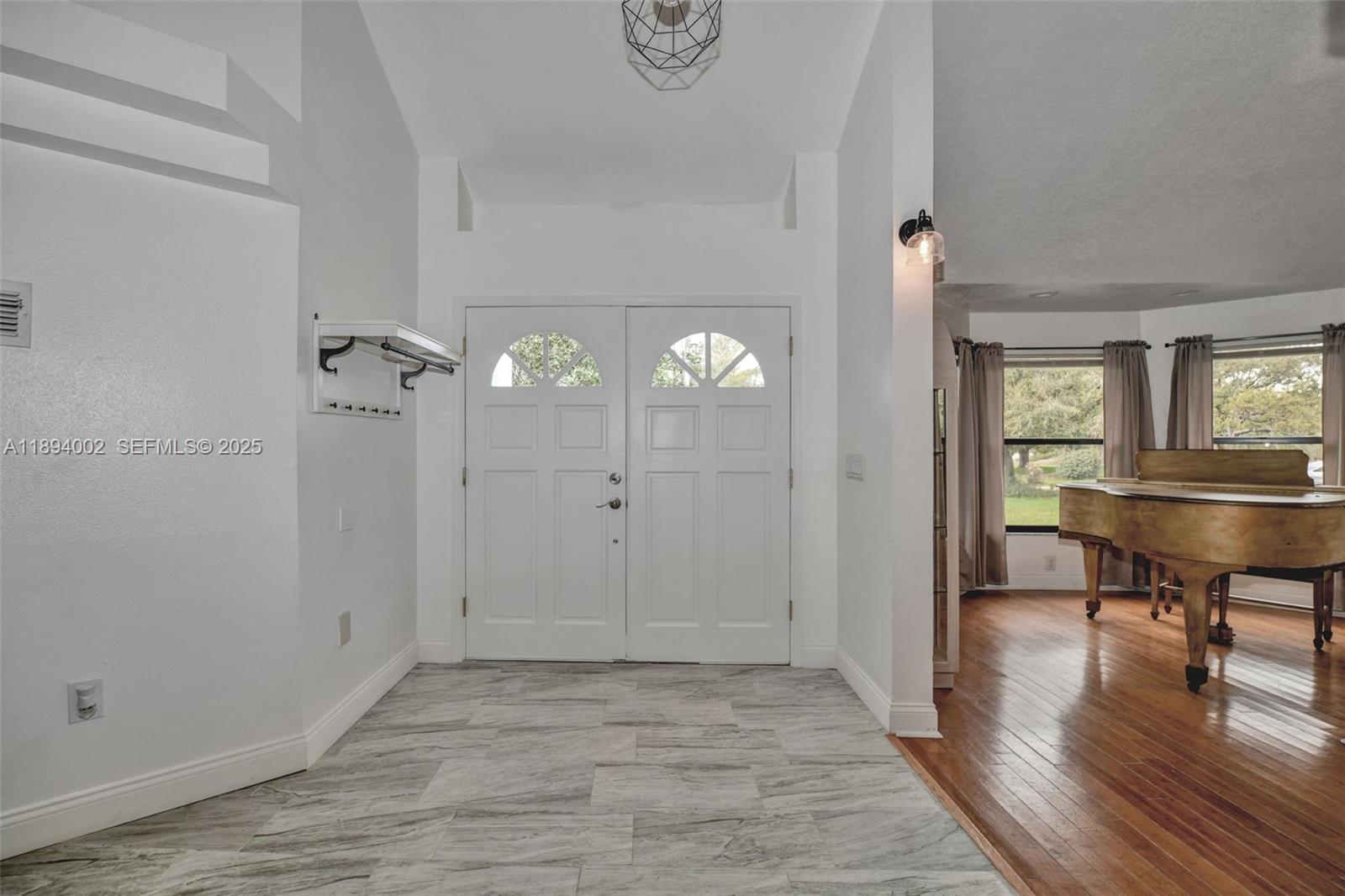 7505 Jomel Drive Spring Hill, FL 34607 - Photo 8 of 44 a view of a room with wooden floor mirror and windows