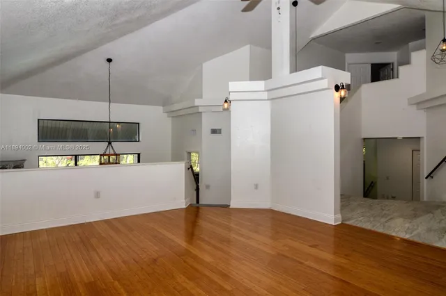 a view of a kitchen with a refrigerator and a ceiling fan