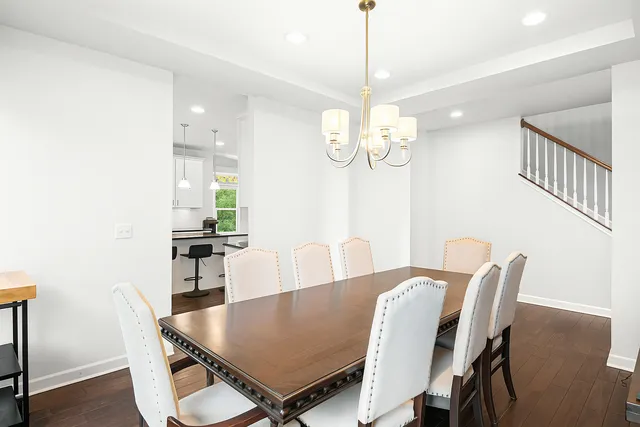 a view of a dining room with furniture a chandelier and wooden floor
