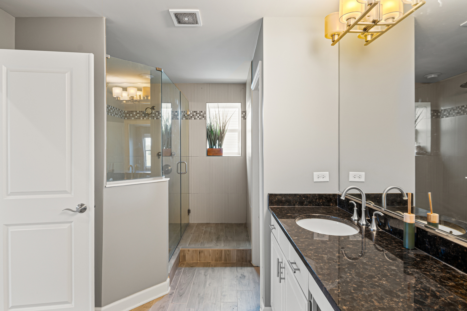 1002 Hudson Drive Joliet, IL 60431 - Photo 25 of 40 a bathroom with a granite countertop sink a mirror and shower