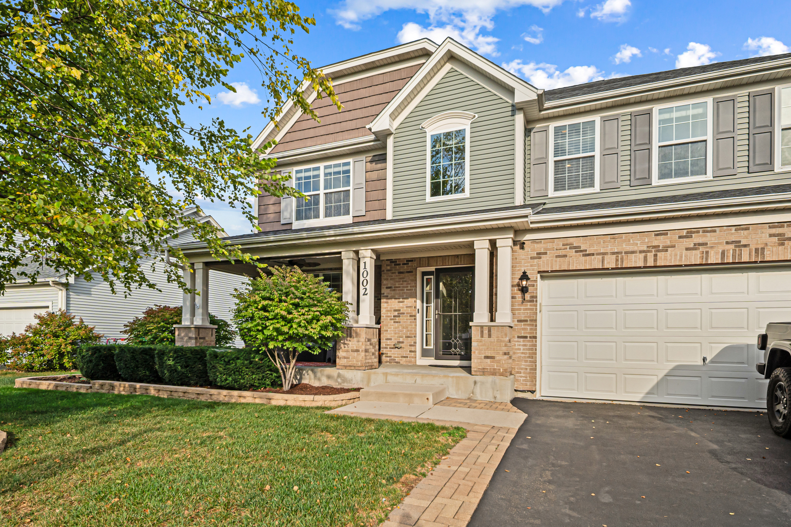 1002 Hudson Drive Joliet, IL 60431 - Photo 3 of 40 a front view of a house with a yard and garage