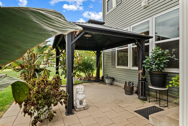 a view of a patio with table and chairs potted plants with wooden fence