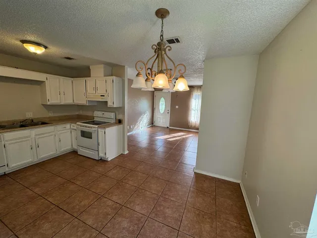 a view of a kitchen with a sink and cabinets