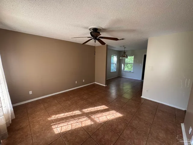 a view of a livingroom with a ceiling fan and window