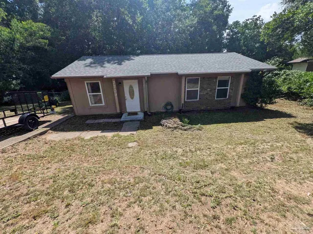a view of a house with a yard and tree