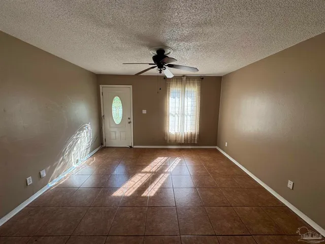 a view of a livingroom with a ceiling fan window and hardwood floor