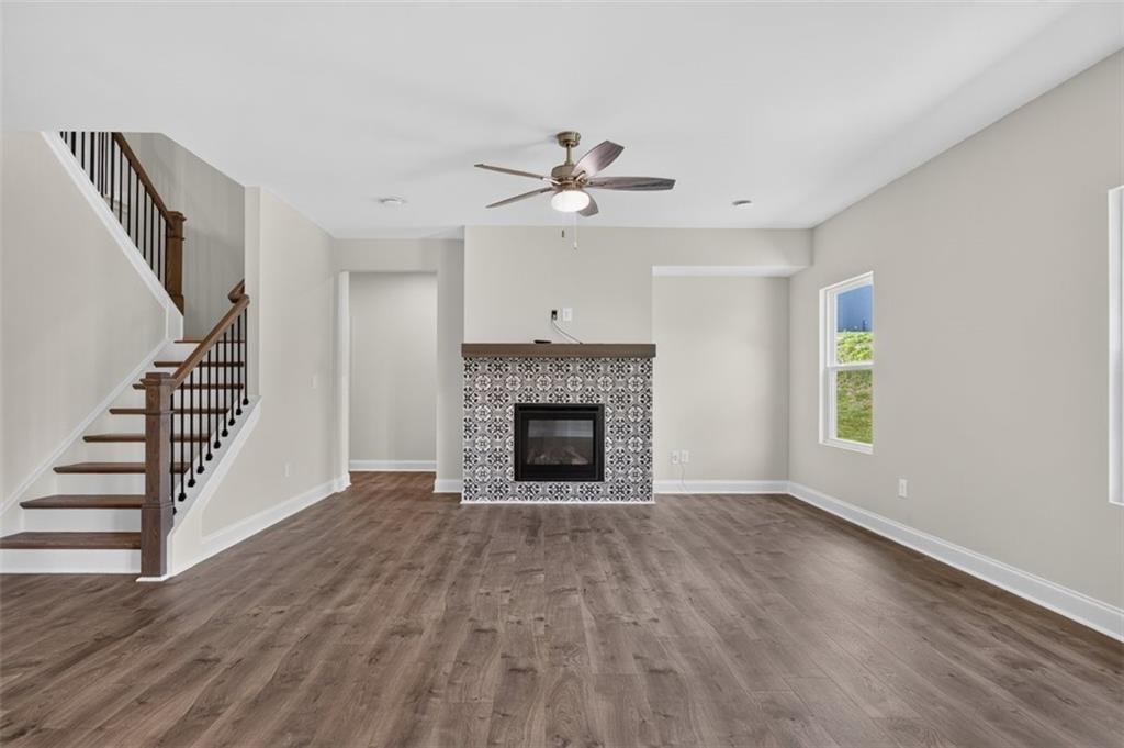 107 Ledgemont Way Acworth, GA 30101 - Photo 13 of 57 a view of an empty room with wooden floor fireplace and a window