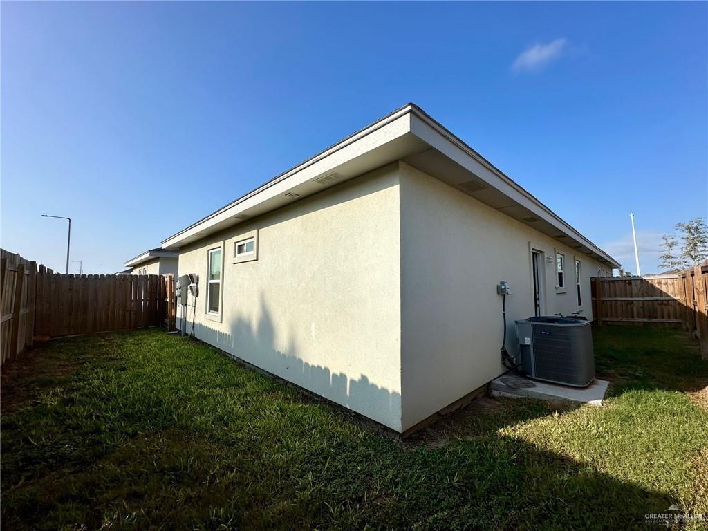 7006 North 56th Lane Mission, TX 78573 - Photo 4 of 14 a backyard of a house with wooden fence