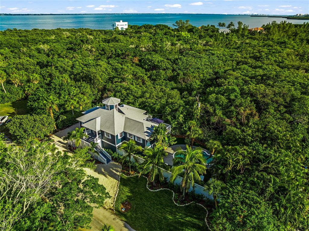 540 Gulf Bay Road Longboat Key, FL 34228 - Photo 1 of 1 a view of a garden with a bench