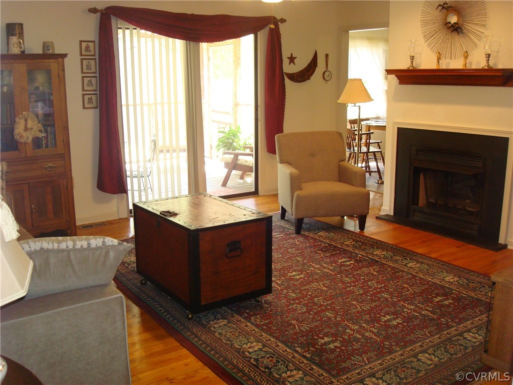 2117 Moseley Road Moseley, VA 23120 - Photo 17 of 39 a living room with furniture and a fireplace