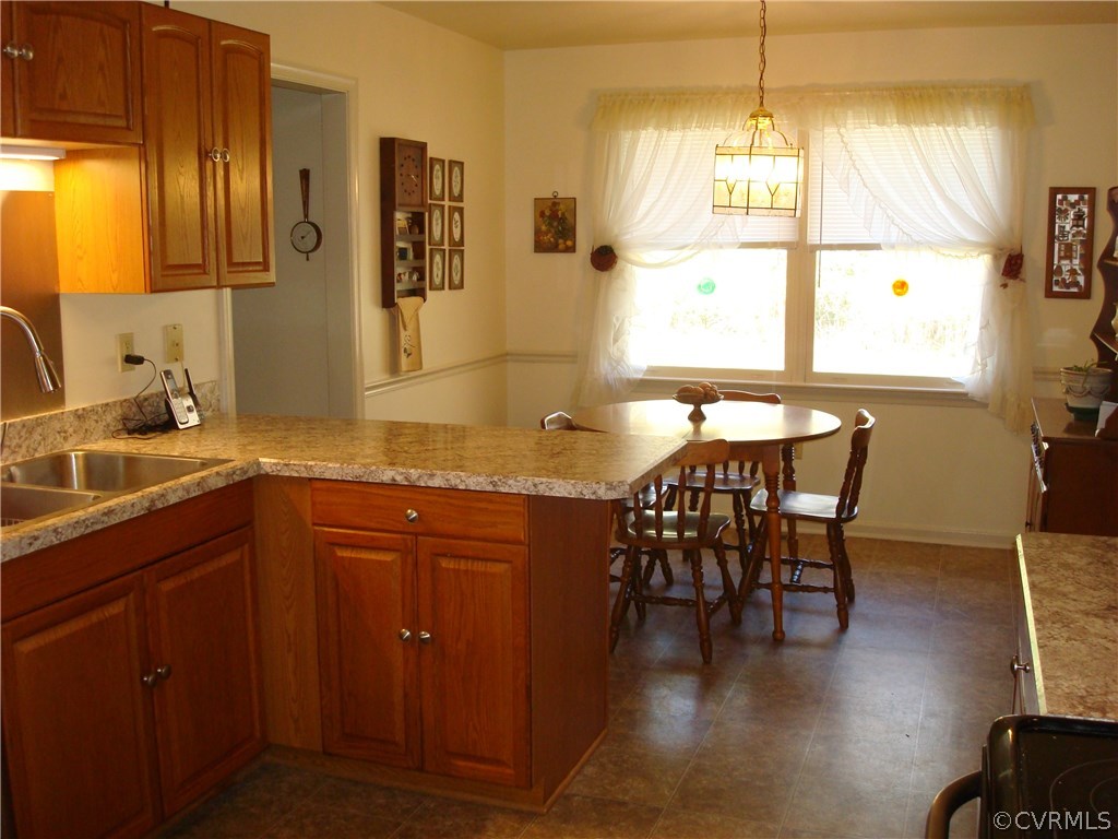 2117 Moseley Road Moseley, VA 23120 - Photo 19 of 39 a kitchen with granite countertop a sink dining table and chairs