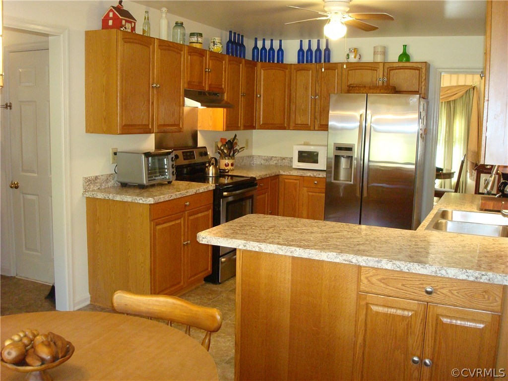 2117 Moseley Road Moseley, VA 23120 - Photo 20 of 39 a kitchen with stainless steel appliances granite countertop a sink a stove and a refrigerator