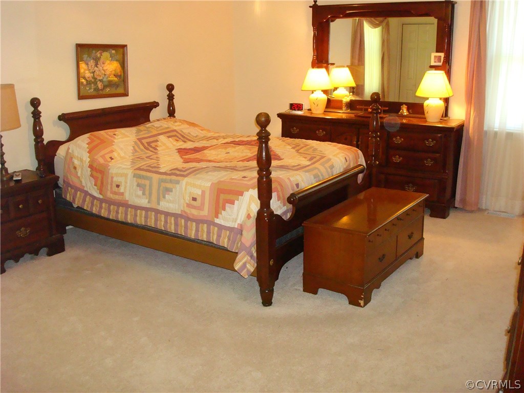 2117 Moseley Road Moseley, VA 23120 - Photo 24 of 39 a bed sitting in a bedroom next to a window