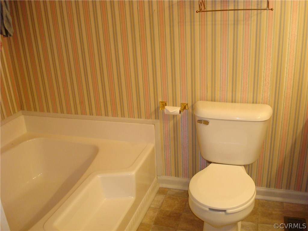 2117 Moseley Road Moseley, VA 23120 - Photo 27 of 39 a bathroom with a toilet and a bathtub