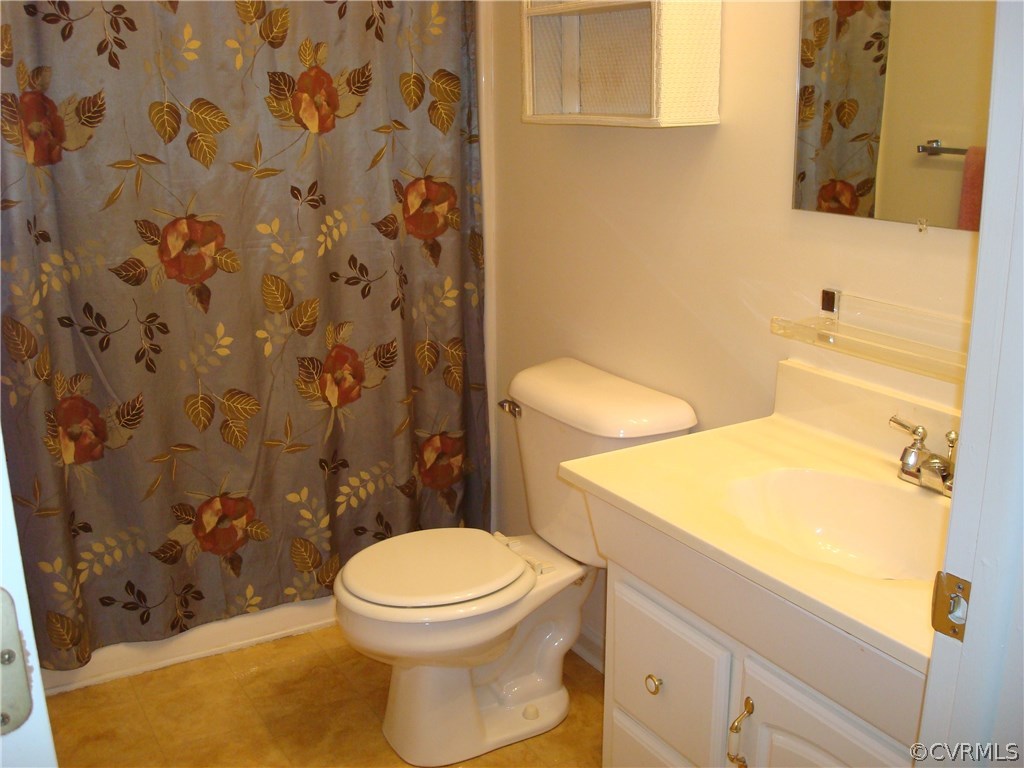 2117 Moseley Road Moseley, VA 23120 - Photo 39 of 39 a white toilet sitting next to a bathroom sink