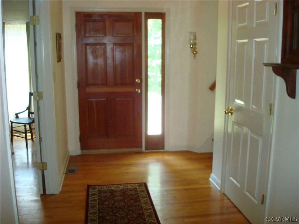 2117 Moseley Road Moseley, VA 23120 - Photo 7 of 39 a view of a hallway with wooden floor and a livingroom