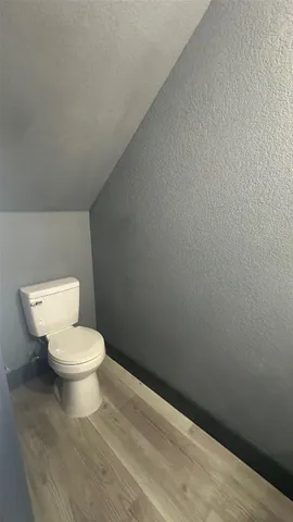 a white toilet sitting next to a white sink