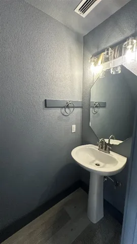 a bathroom with a sink a mirror and a toilet