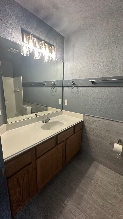 38 Deer Ridge Road Wimberley, TX 78676 - Photo 17 of 26 a bathroom with a sink a large mirror and a light fixture