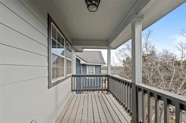 a view of a balcony with wooden floor