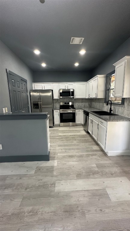 38 Deer Ridge Road Wimberley, TX 78676 - Photo 7 of 26 a large kitchen with stainless steel appliances kitchen island a large counter top and a wooden floor