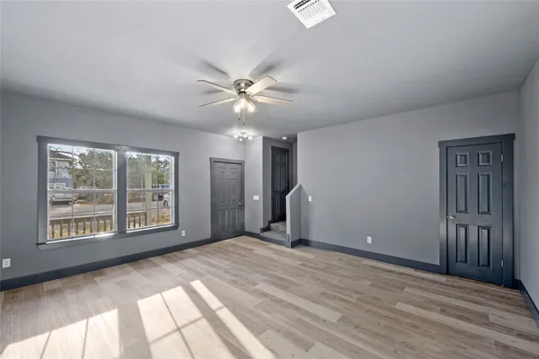 wooden floor in an empty room with a window
