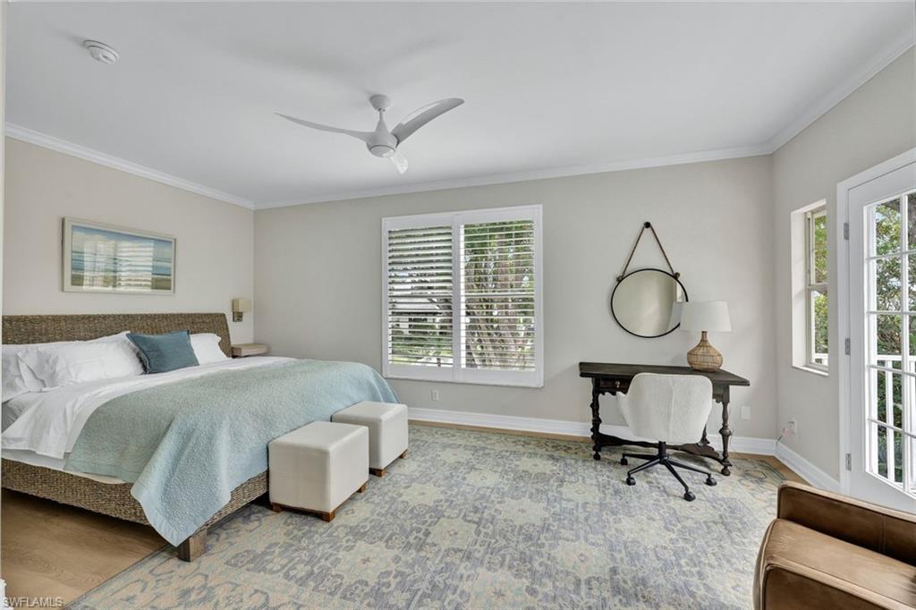 255 2nd Avenue North Naples, FL 34102 - Photo 15 of 32 a bed room with a bed and a chandelier