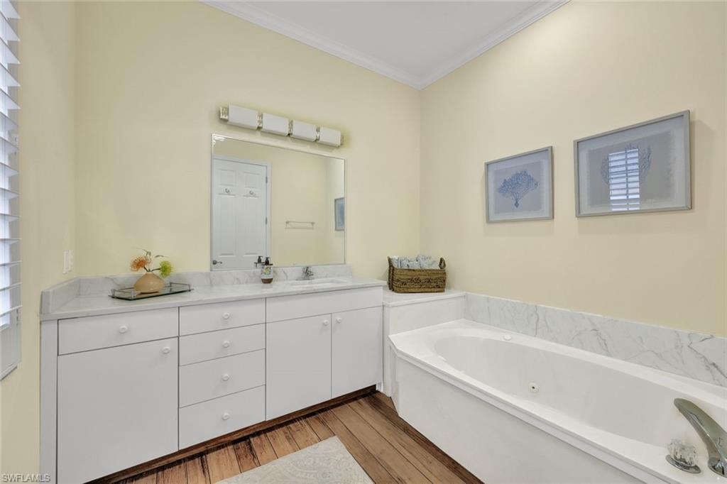 255 2nd Avenue North Naples, FL 34102 - Photo 18 of 32 a bathroom with a tub sink and mirror