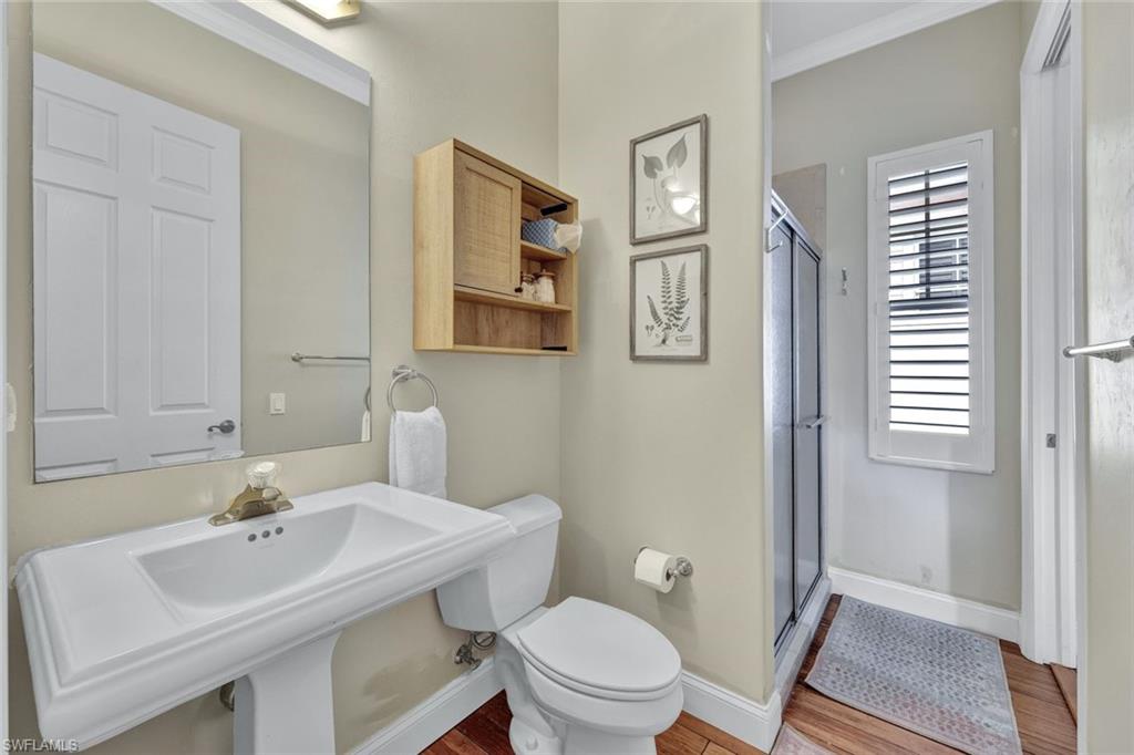 255 2nd Avenue North Naples, FL 34102 - Photo 20 of 32 a bathroom with a sink toilet and a mirror