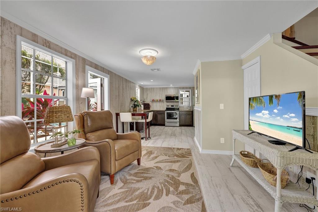 255 2nd Avenue North Naples, FL 34102 - Photo 21 of 32 a living room with furniture and a flat screen tv