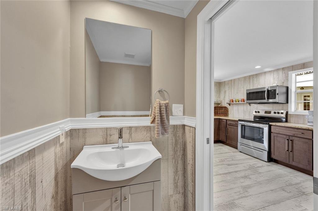 255 2nd Avenue North Naples, FL 34102 - Photo 23 of 32 a bathroom with a sink and a mirror