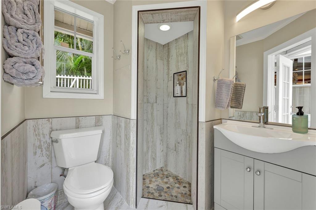 255 2nd Avenue North Naples, FL 34102 - Photo 25 of 32 a bathroom with a toilet sink and shower