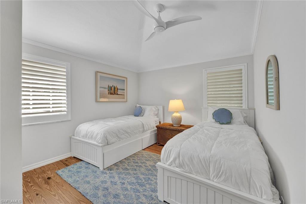255 2nd Avenue North Naples, FL 34102 - Photo 26 of 32 a bedroom with two beds and painting on the wall