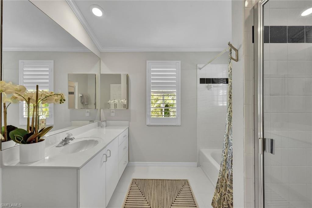 255 2nd Avenue North Naples, FL 34102 - Photo 27 of 32 a bathroom with a tub sink and mirror