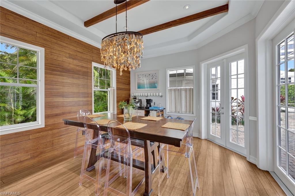 255 2nd Avenue North Naples, FL 34102 - Photo 8 of 32 a view of a dining room with furniture wooden floor and chandelier