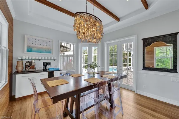a view of a dining room with furniture wooden floor and chandelier