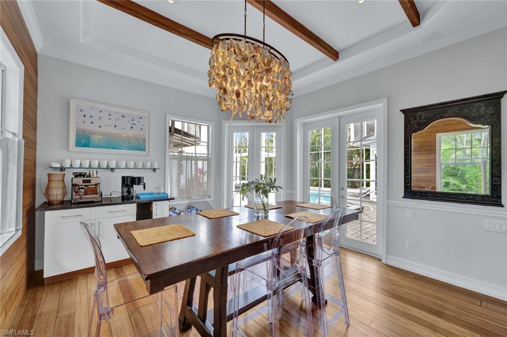 255 2nd Avenue North Naples, FL 34102 - Photo 9 of 32 a view of a dining room with furniture wooden floor and chandelier