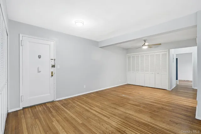 a view of an empty room with wooden floor