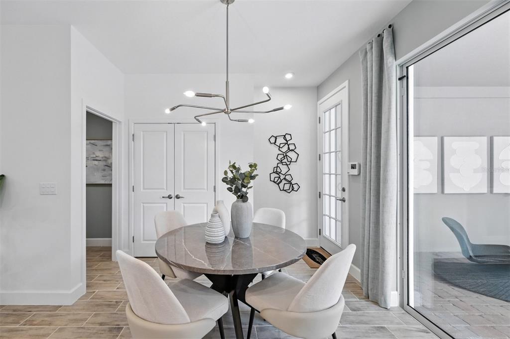 1475 Seashore Circle Celebration, FL 34747 - Photo 11 of 31 a view of a dining room with furniture and wooden floor