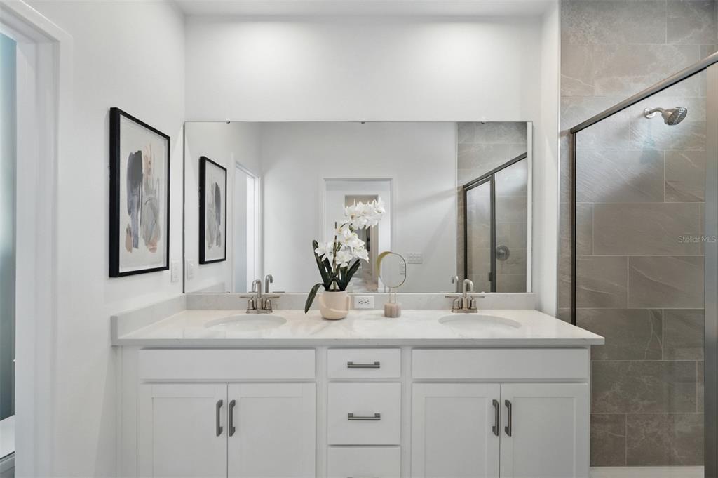 1475 Seashore Circle Celebration, FL 34747 - Photo 14 of 31 a bathroom with double sink and a mirror
