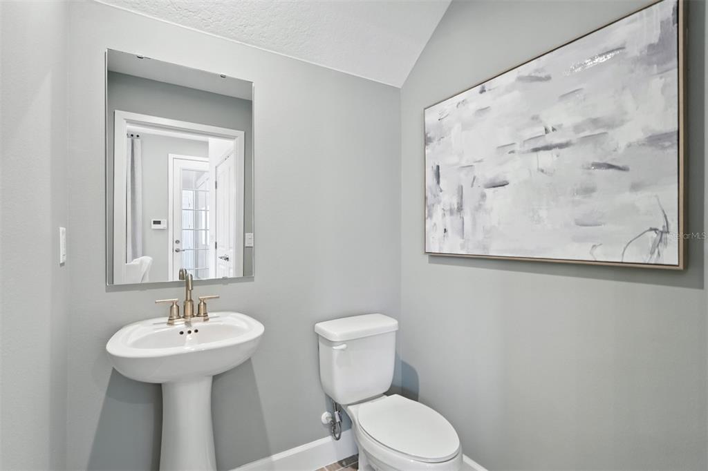 1475 Seashore Circle Celebration, FL 34747 - Photo 18 of 31 a bathroom with a toilet sink and mirror