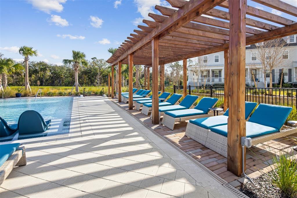 1475 Seashore Circle Celebration, FL 34747 - Photo 28 of 31 a view of a patio with a table and chairs next to a yard