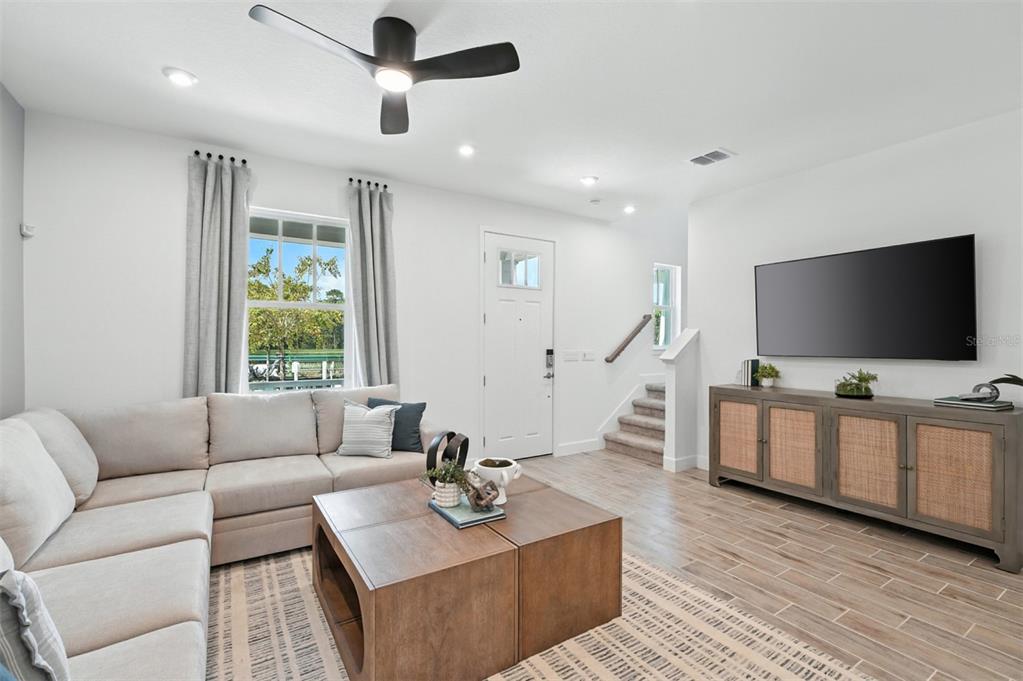 1475 Seashore Circle Celebration, FL 34747 - Photo 8 of 31 a living room with furniture and a flat screen tv