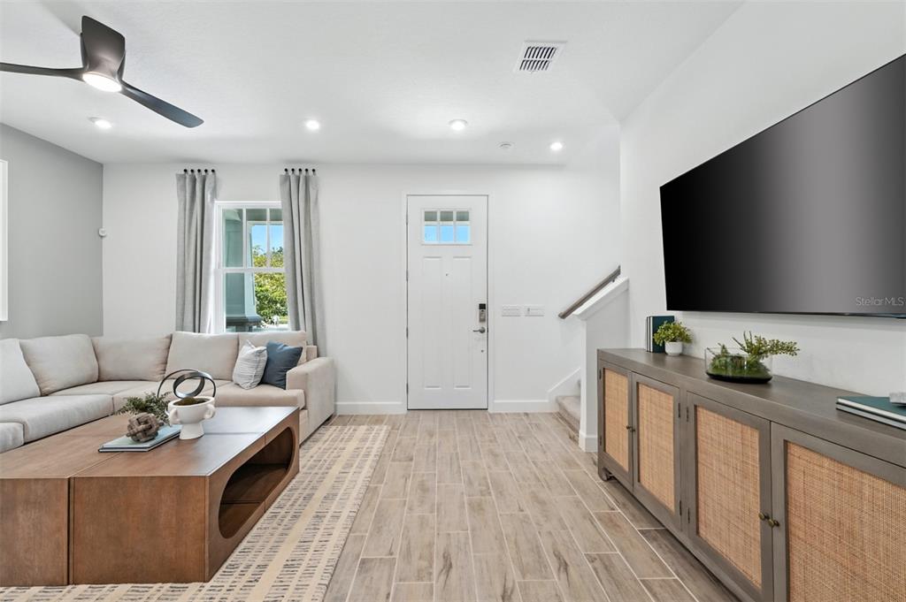 1475 Seashore Circle Celebration, FL 34747 - Photo 10 of 31 a living room with furniture and a flat screen tv