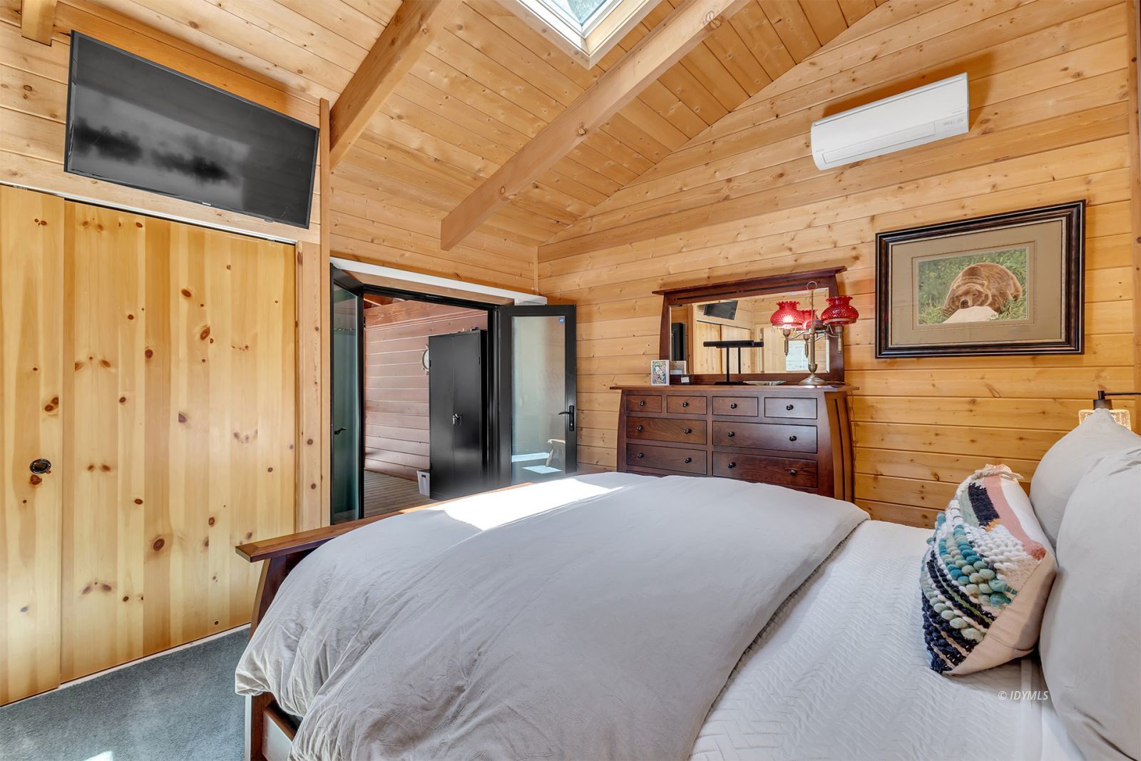 24924 Fern Valley Road Idyllwild, CA 92549 - Photo 55 of 72 a bedroom with a bed and a flat screen tv