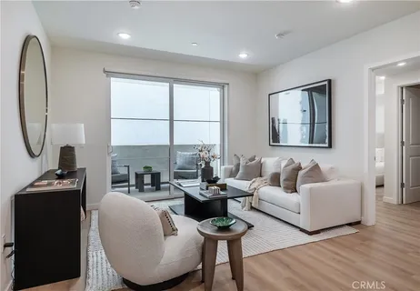 a living room with fireplace furniture and a window