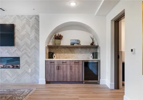 a living room with a fireplace and a wooden floor