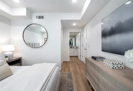 a bedroom with a bed and a mirror