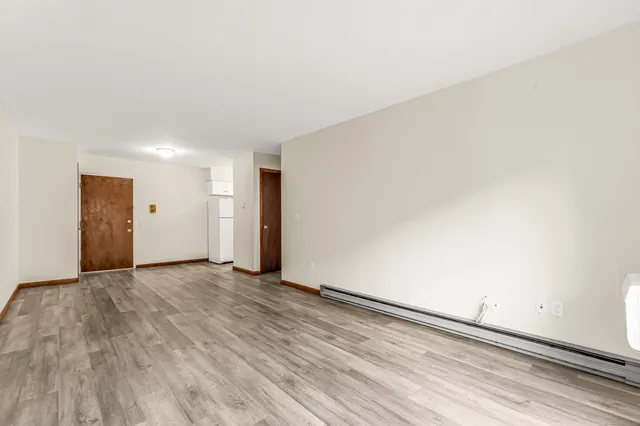 a view of an empty room and wooden floor