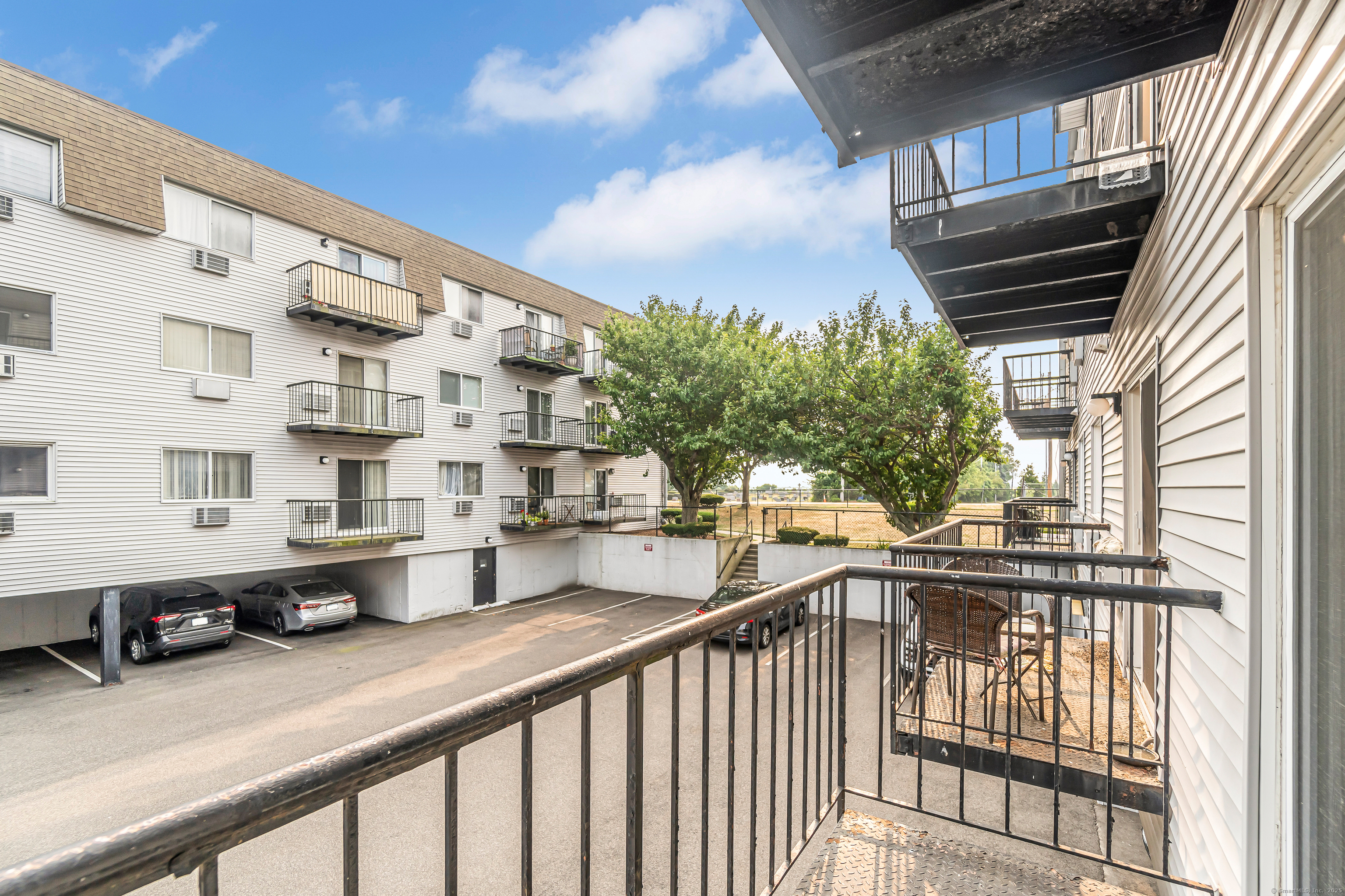 115 Short Beach Road, Unit 103 Stratford, CT 06615 - Photo 15 of 18 a view of a tall building from a balcony